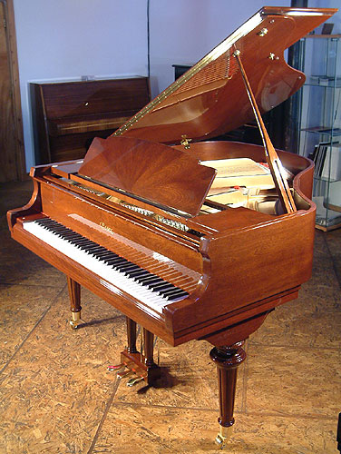 A new Essex EGP 155 baby grand piano with a walnut case and polyester finish. Designed by Steinway & Sons