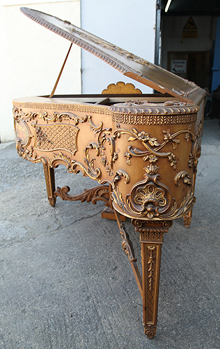 Claviano grand piano built for songwriter and film star Ivor Novello. This piano has an ornately carved, rococo style case with gilt accents