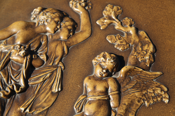 High relief carvings of grecian ladies and cherub on piano lid  