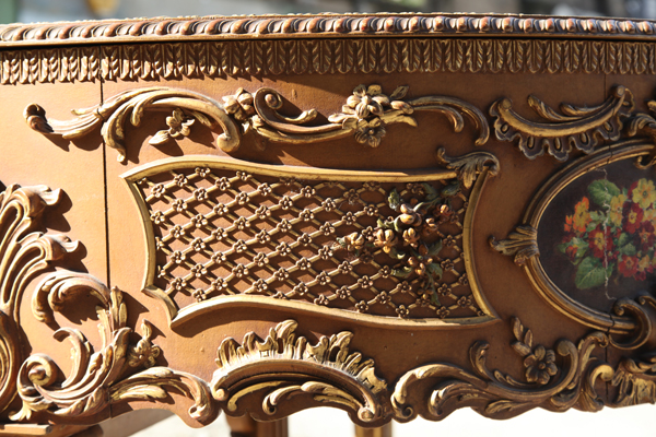 Claviano cabinet showing ornate rococo carvings with gilt accents