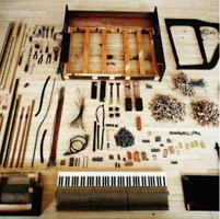 Component parts of a piano laid out on the floor