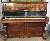 An art cased Broadwood upright piano with a rosewood case with inlaid with a scroll design.