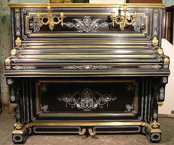 Debain et Cie upright piano with an ebonised case. Intricately inlaid with ivory. Case covered with brass ormulu mounts. 