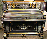An art cased Debain et Cie upright piano with an ebonised case. Intricately inlaid with ivory. Case covered with brass ormulu mounts. Instrument restored.