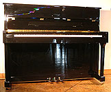 A brand new Halle & Voight upright piano with a black case and polyester finish.