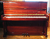 A brand new Halle & Voight upright piano with a walnut case and polyester finish. 