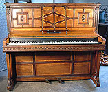 An art cased Hopkinson upright piano with a polished, rosewood case, inlaid with a variety of woods and carved detail.