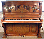 An art cased Gerhard Adams upright piano with a polished, rosewood case and carved panels in an Art Nouveau design.