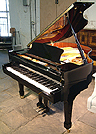 A brand new, Halle & Voight WG160 grand piano with a black case and polyester finish. 
