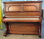 A restored Steinway upright piano with an inlaid, rosewood case. 