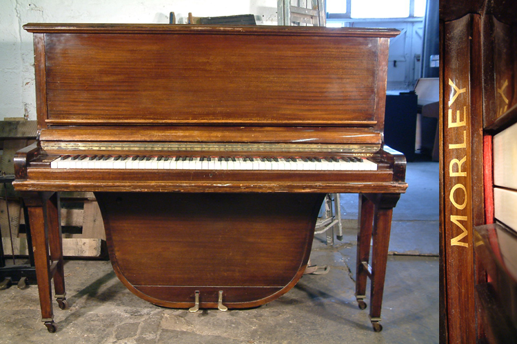 A Morley upright grand piano with a polished, mahogany case. 