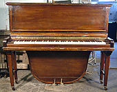A Morley upright grand piano with a polished, mahogany case.