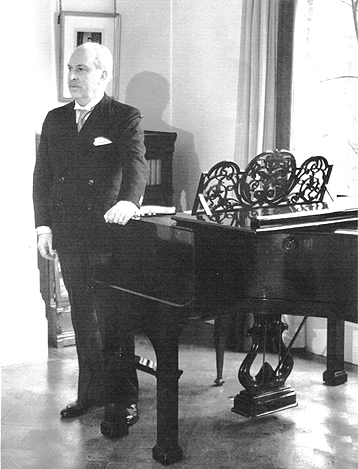 Arthur Bliss standing by his Bluthner Grand