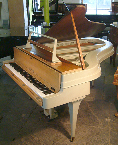 A 1959, Rippen grand piano with an aluminium case. This Rippen piano has a beautiful elegant outline. Piano features a reverse crown soundboard and tapered legs.