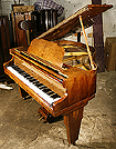 An Art Deco Monington and Weston baby grand piano with a repolished walnut case. Ideal for a smaller space.