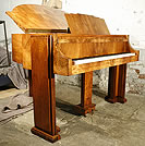 An Art-deco Strohmenger baby grand piano with a figured walnut case. 