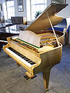 A Bechstein Model M grand piano with a polished, walnut case. 