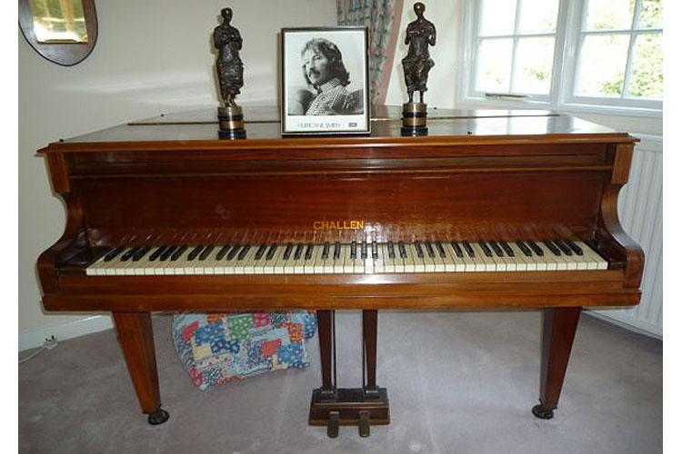 Challen piano at former residence with awards and photo of Hurricane Smith