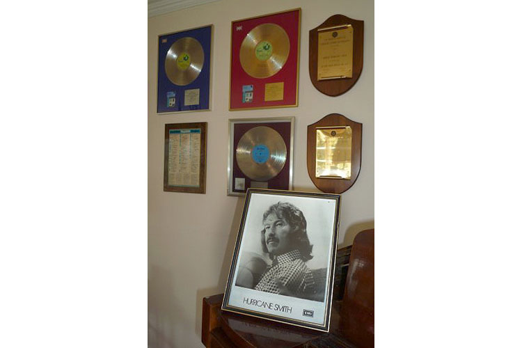 Photo of Hurricane Smith with awards for work in the music industry