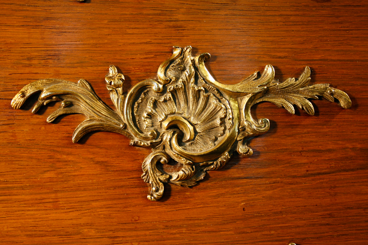 Ornate, brass Ormulu Mounts cover the entire case