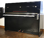A Steinway Model Z upright piano with a black case and polyester finish. 