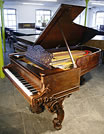 An  Steinway concert grand piano with a rosewood case and beautifully carved legs