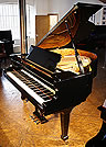 A Fazioli F156 grand piano with a black case and polyester finish. 