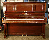 A preowned Steinway Model K upright piano with a   mahogany case. 