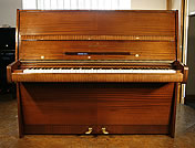 A  Steinway Model V upright piano with a mahogany case. 