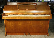 An Eavestaff mini piano with a mahogany case.