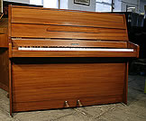 A  Kemble upright piano with a black case and polyester finish.