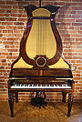 An antique Klein lyre piano with a rosewood case.