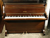 A Steck upright piano with a mahogany case. 