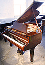 A Steinway Model S grand piano with a mahogany case. 