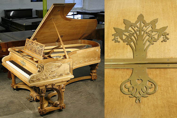 A unique, 1895, Bechstein Model C grand piano with an ornately carved, walnut case. Cabinet features carvings of two swans on the water on piano cheeks. Twisted around the rear piano leg is a two-headed serpent dragont