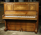 An inlaid,  Bechstein  upright piano with a rosewood case. 