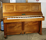 A Laurence upright piano with a mahogany case.