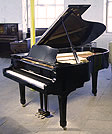 A Yamaha C5 grand piano for sale with a black case and polyester finish. 