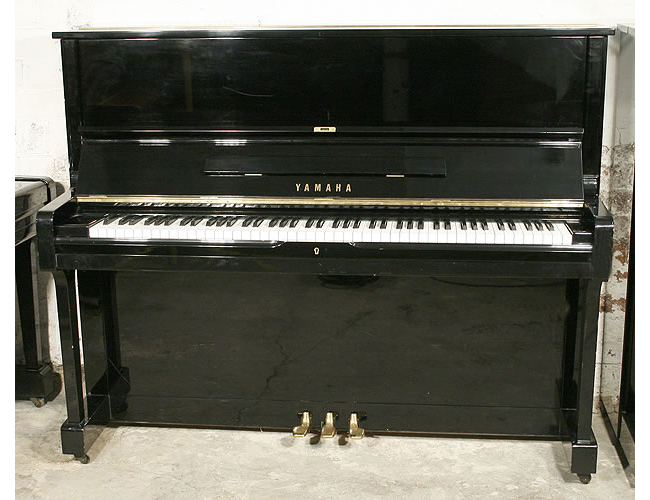 A Yamaha U1 upright piano with a black case and polyester finish 