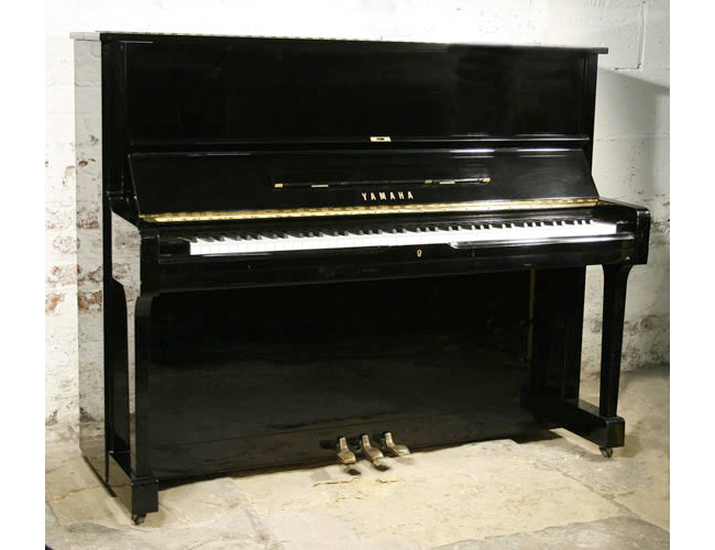 A Yamaha U1 upright piano with a black case and polyester finish