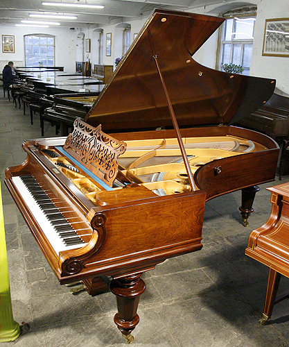 An Antique, 1885 Bechstein Model D grand piano with a polished, rosewood case and turned legs
