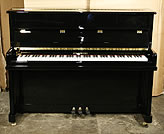 A brand new Steinhoven Model 110 upright piano with a black case. 