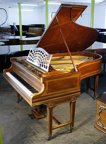 An 1884, Bechstein Model B grand piano with a mahogany case and gate legs, inlaid with satinwood stringing.