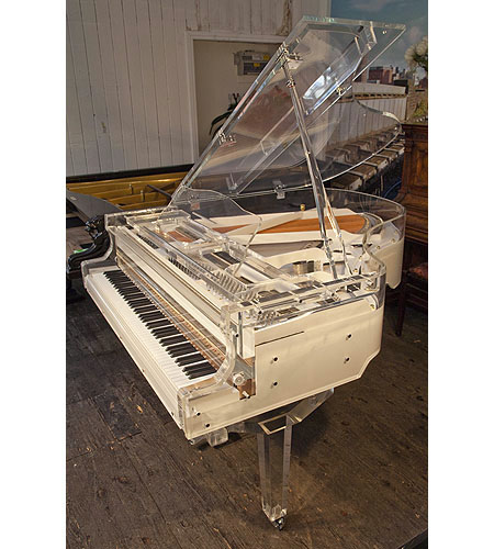 Brand new, Steinhoven grand piano with a transparent, acrylic case.  Piano has an eighty-eight note keyboard and a three-pedal piano lyre.