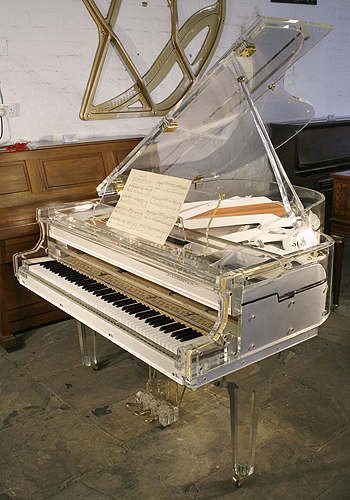 A Steinhoven grand piano with a transparent, acrylic case