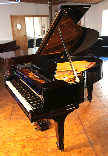 A 1910, Steinway Model O grand piano with a black case and spade legs