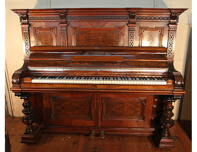A restored, Glass upright piano with an ornate, walnut case and carved detail