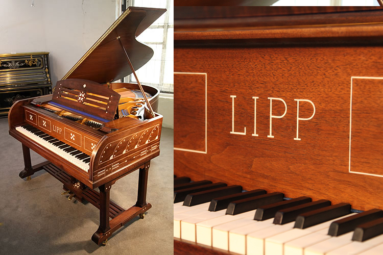 An Arts and Crafts, Lipp grand piano for sale with a mahogany case inlaid with symbols