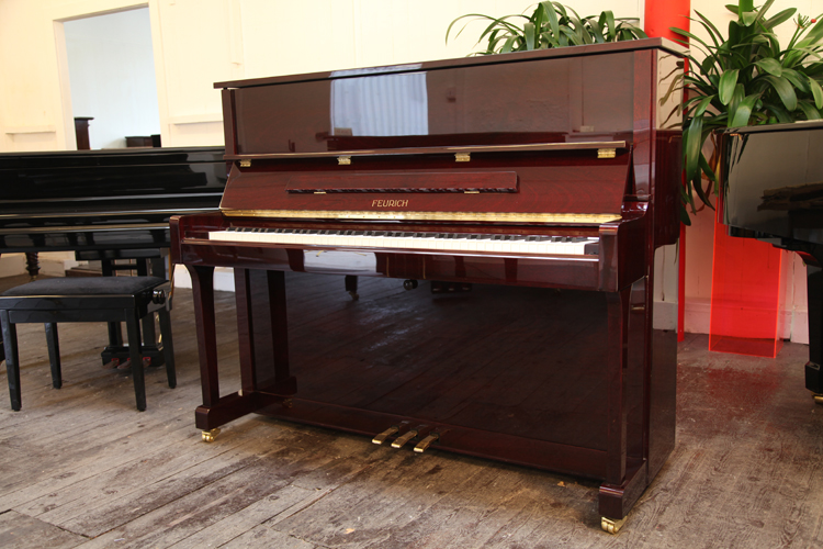 Brand new,  Feurich Model 122 upright piano with a mahogany case and polyester finish