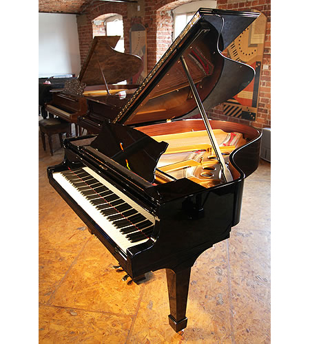 A 1926, Steinway Model O grand piano with a black case and spade legs